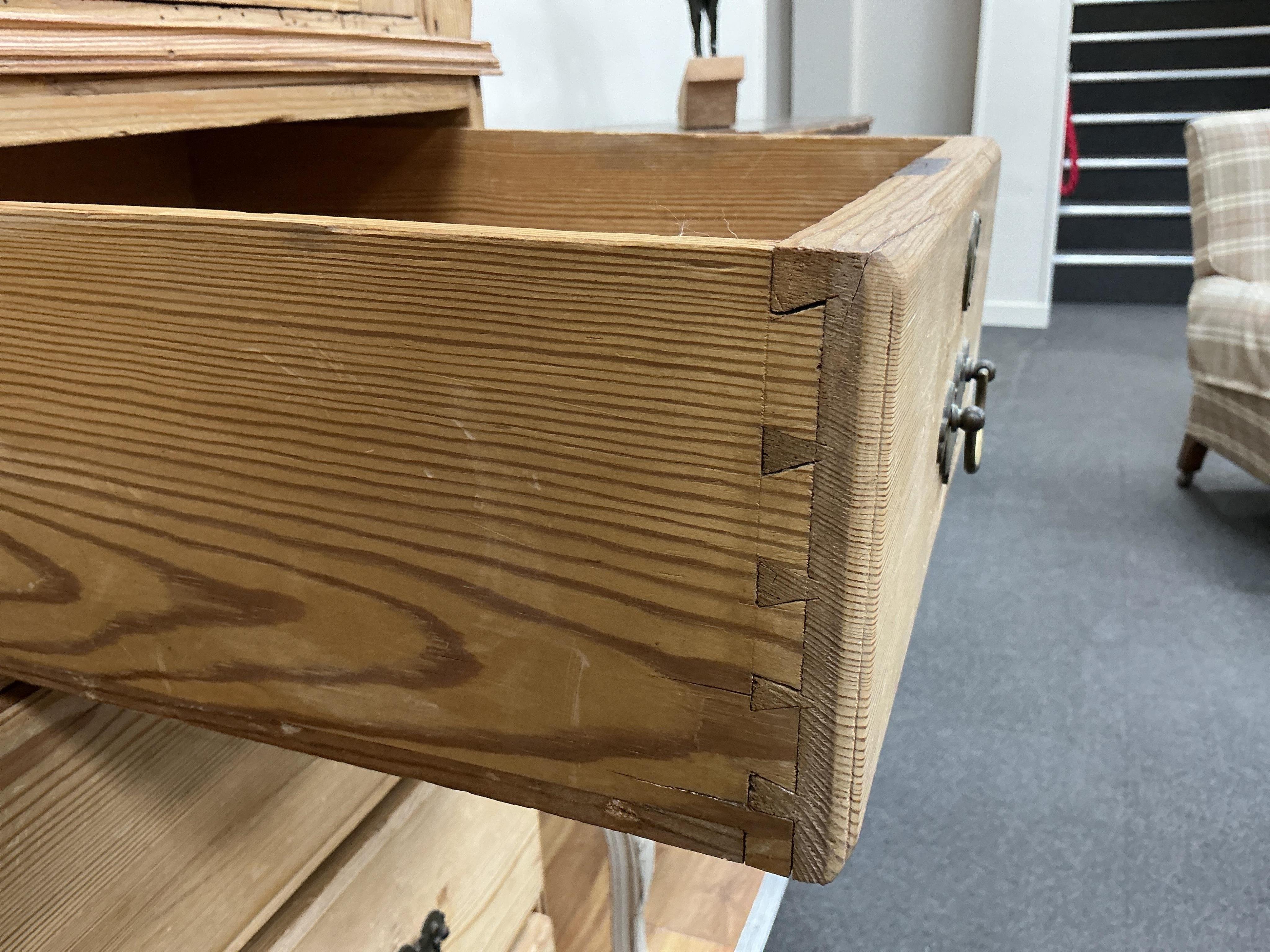 An early 19th century pine two part press cupboard, width 125cm, depth 54cm, height 191cm